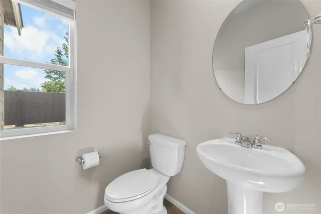 a bathroom with a sink a toilet and a mirror