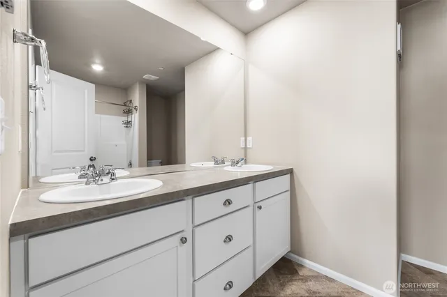 a bathroom with a double vanity sink and a mirror