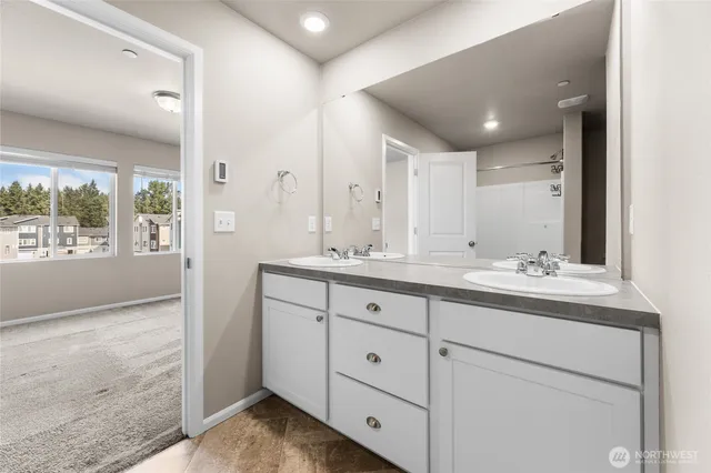 a bathroom with double sink and a mirror