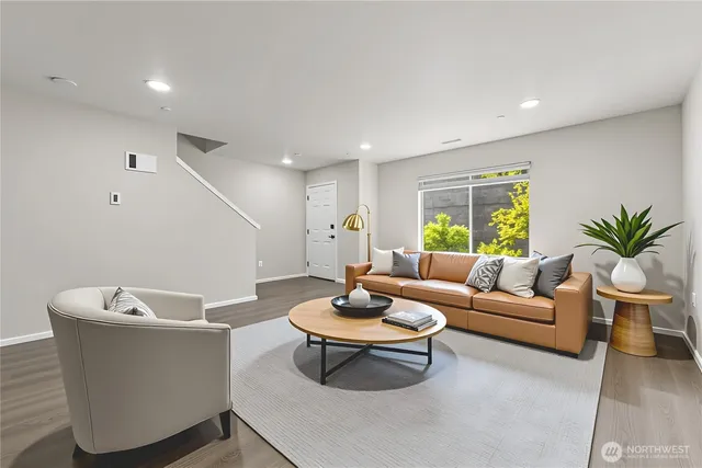 a living room with furniture and a large window