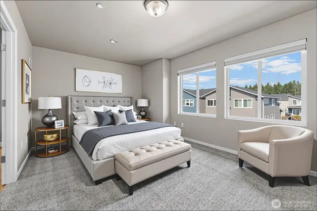 a bedroom with a bed and a large window