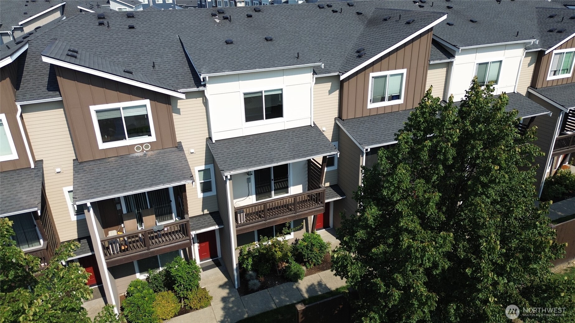 17417 118th Ave Court East, Unit E Puyallup, WA 98374 - Photo 31 of 31 a view of a house with a yard and potted plants