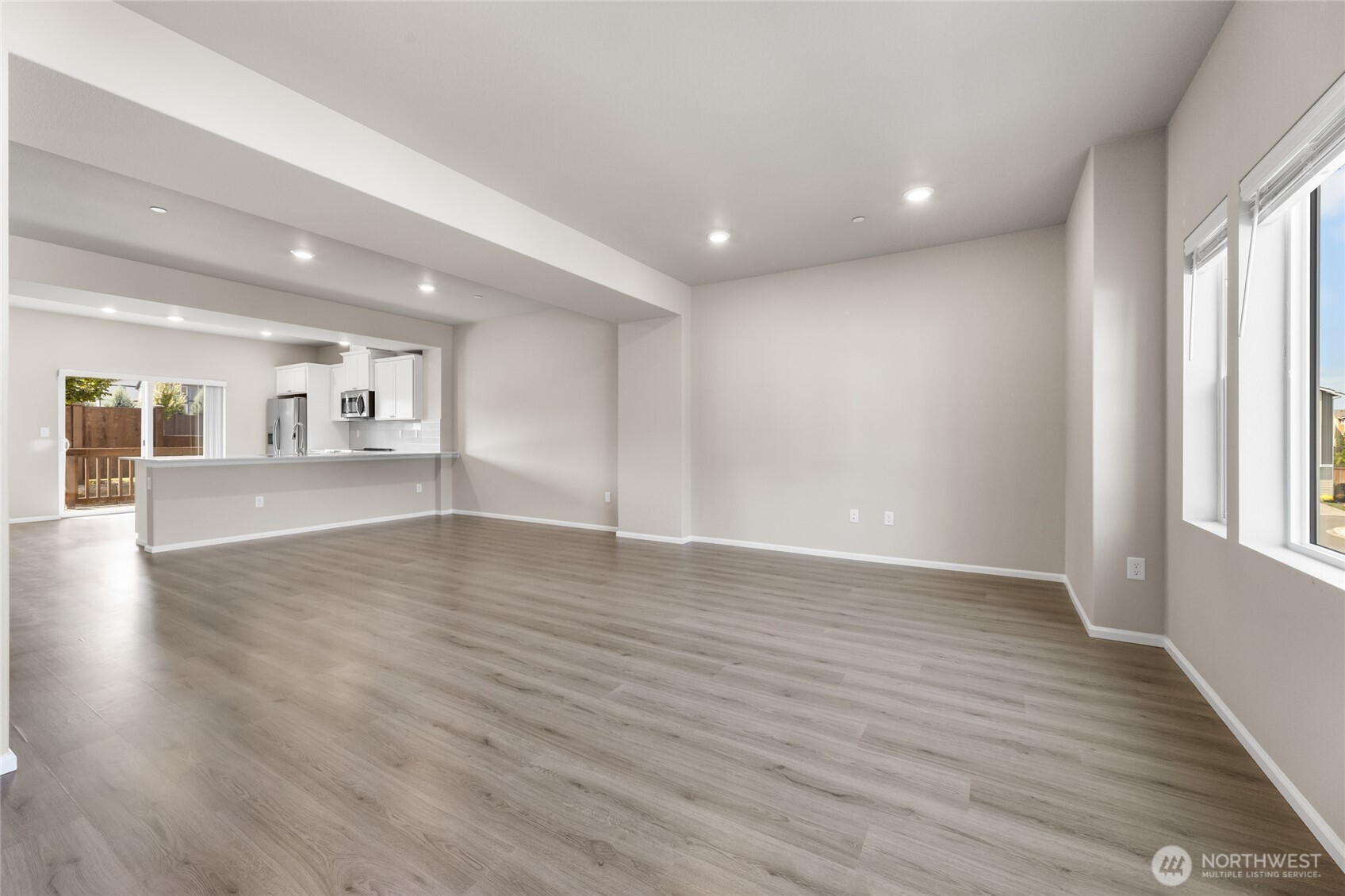 17417 118th Ave Court East, Unit E Puyallup, WA 98374 - Photo 7 of 31 wooden floor in an empty room with a window