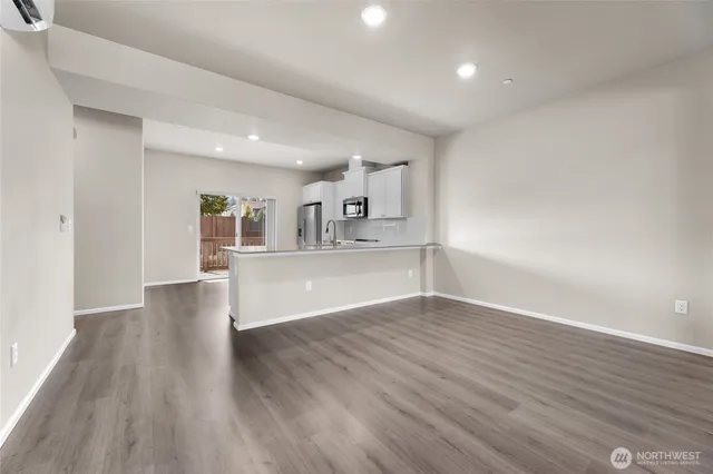 a view of kitchen and hall with wooden floor