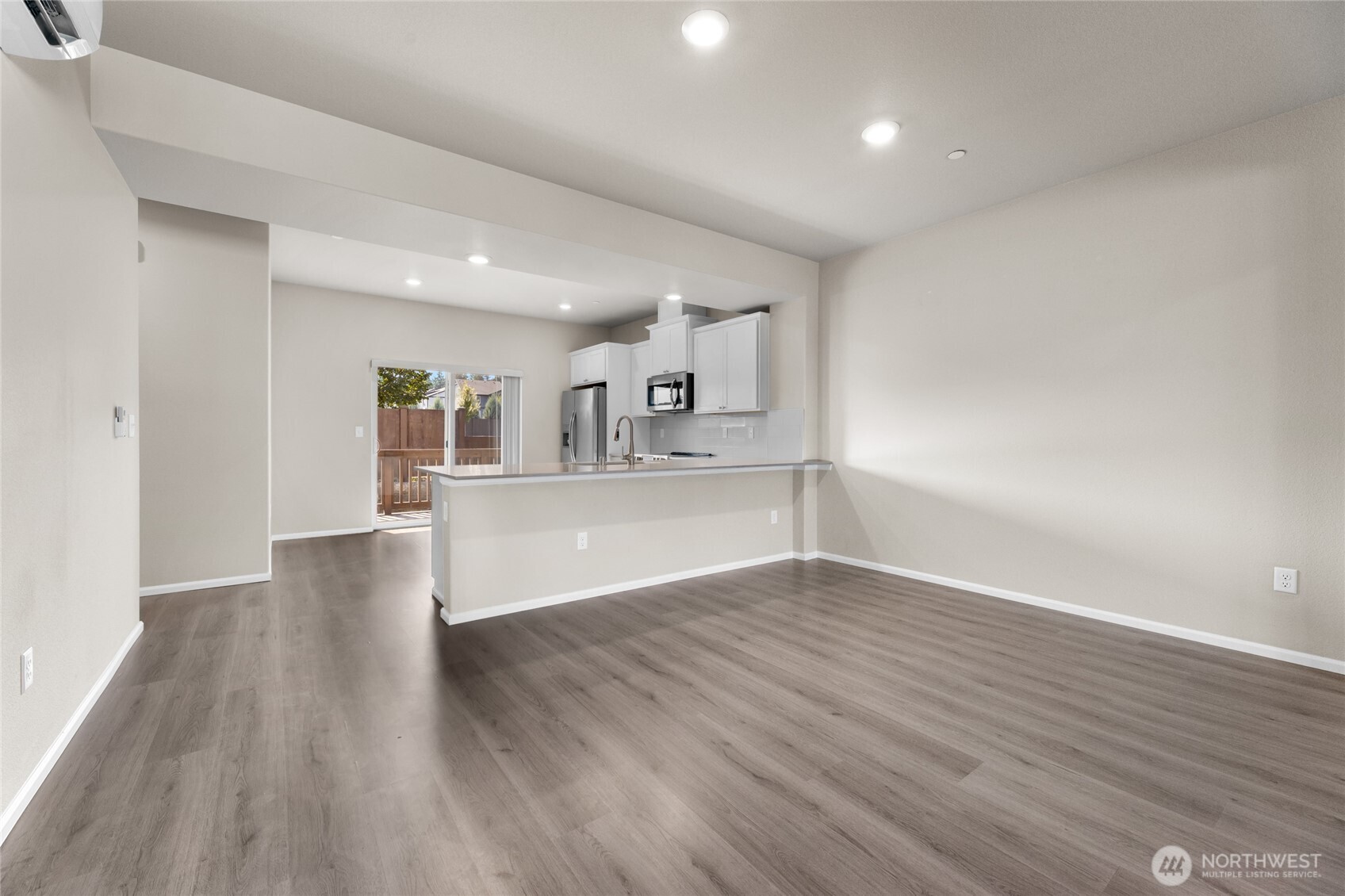 17417 118th Ave Court East, Unit E Puyallup, WA 98374 - Photo 9 of 31 a view of kitchen and hall with wooden floor