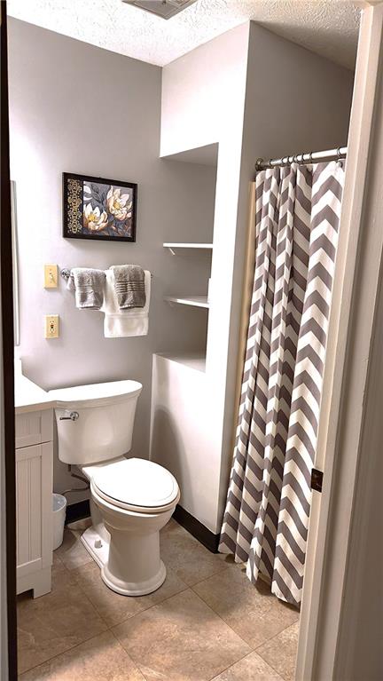 830 South Main Street, Unit 211 Washington, PA 15301 - Photo 12 of 17 a white toilet sitting next to a shower curtain