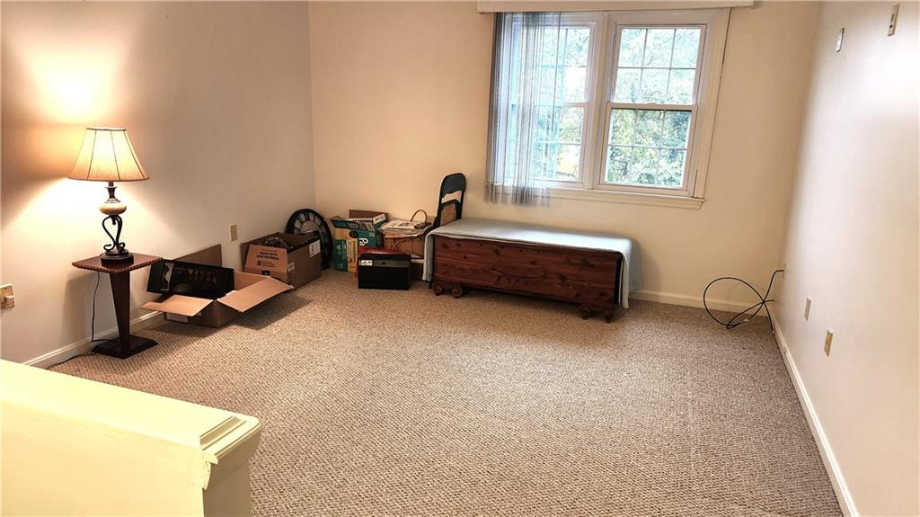 830 South Main Street, Unit 211 Washington, PA 15301 - Photo 10 of 17 a spacious bedroom with a bed and a lamp on table