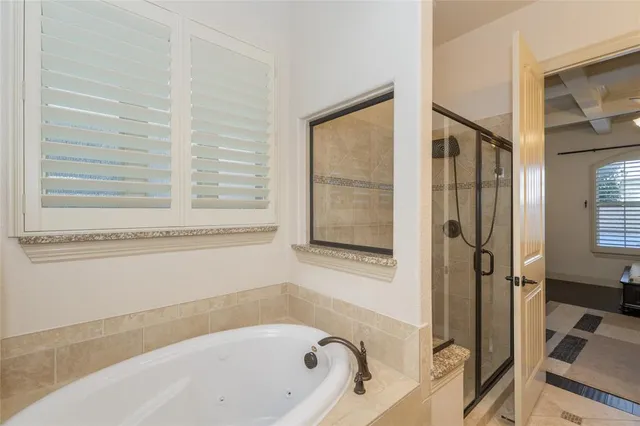 a bathroom with a bathtub and a shower