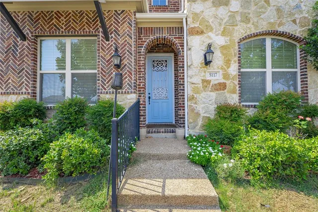 front view of a brick house with a large windows