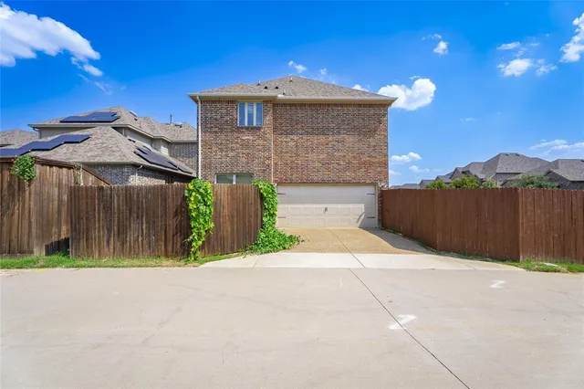 an aerial view of residential houses with outdoor space and swimming pool
