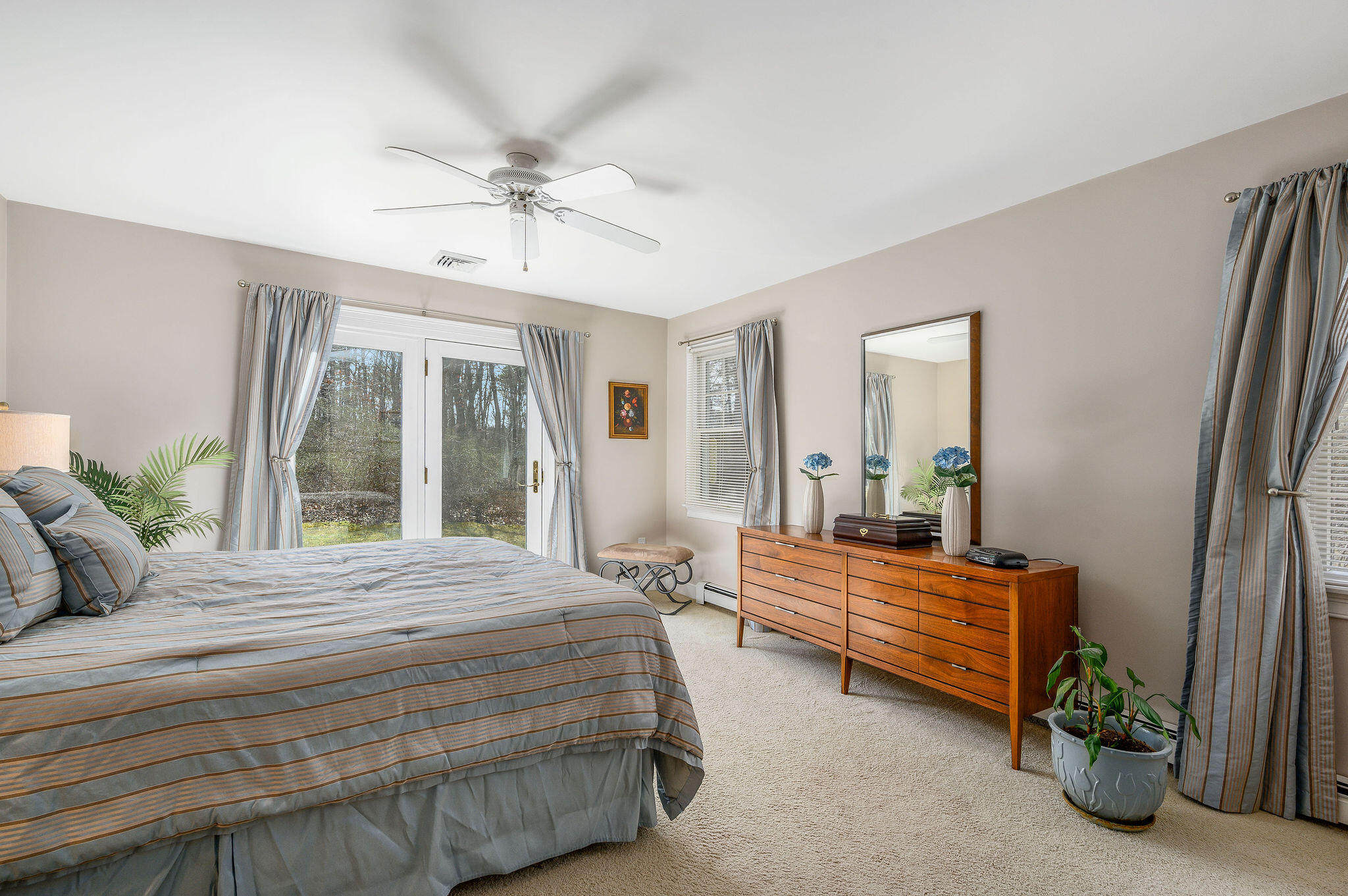 78 Red Maple Road Brewster, MA 02631 - Photo 20 of 39 a bedroom with a bed and large windows