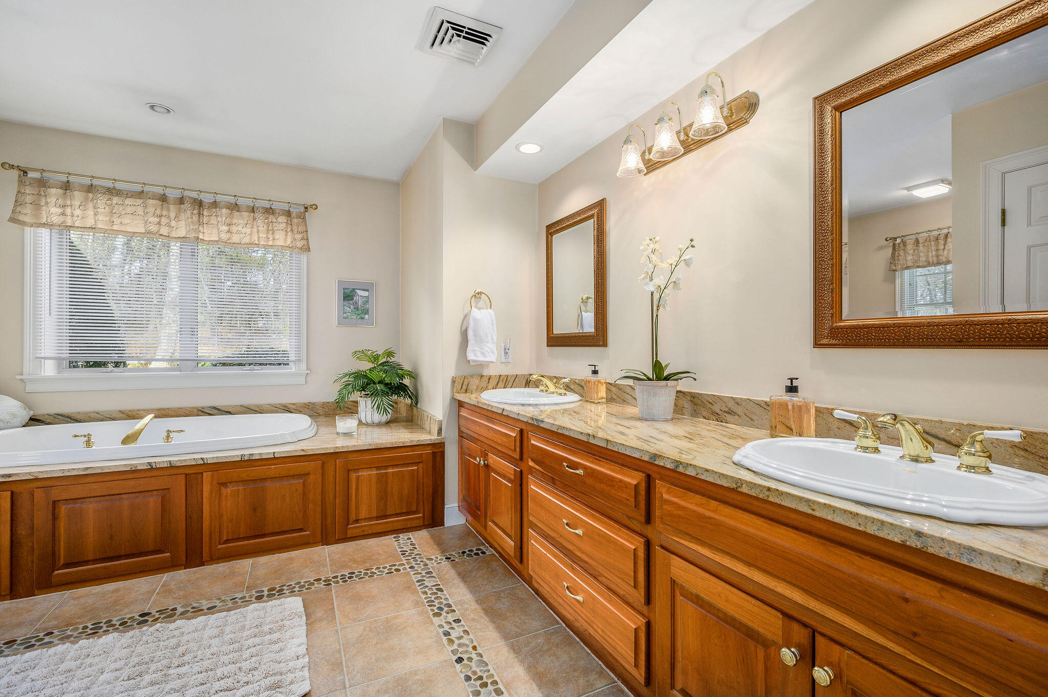 78 Red Maple Road Brewster, MA 02631 - Photo 23 of 39 a spacious bathroom with a double vanity sink large mirror and a bathtub