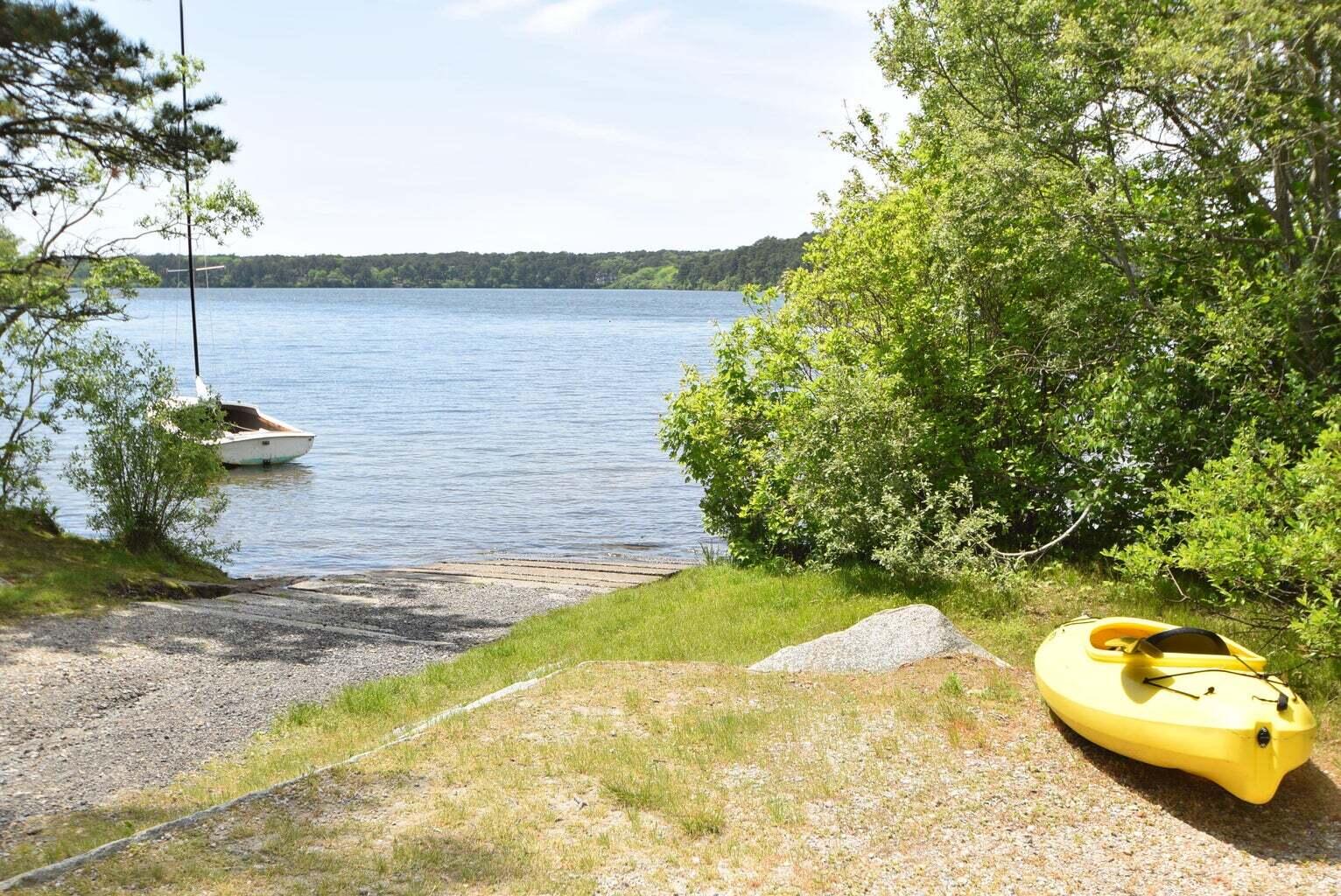 78 Red Maple Road Brewster, MA 02631 - Photo 3 of 39 a view of a lake with a patio