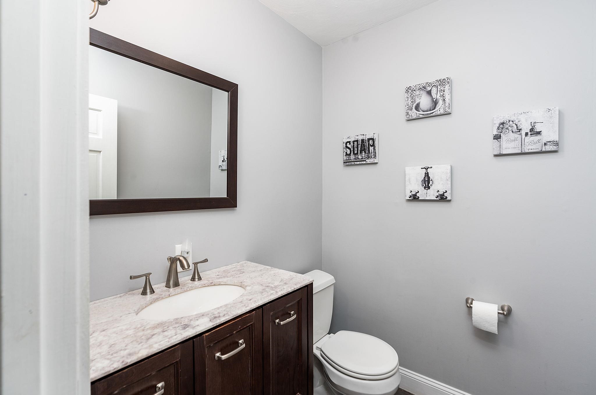 441 Barrenridge Road Fishersville, VA 22939 - Photo 30 of 71 a bathroom with a granite countertop toilet sink and mirror