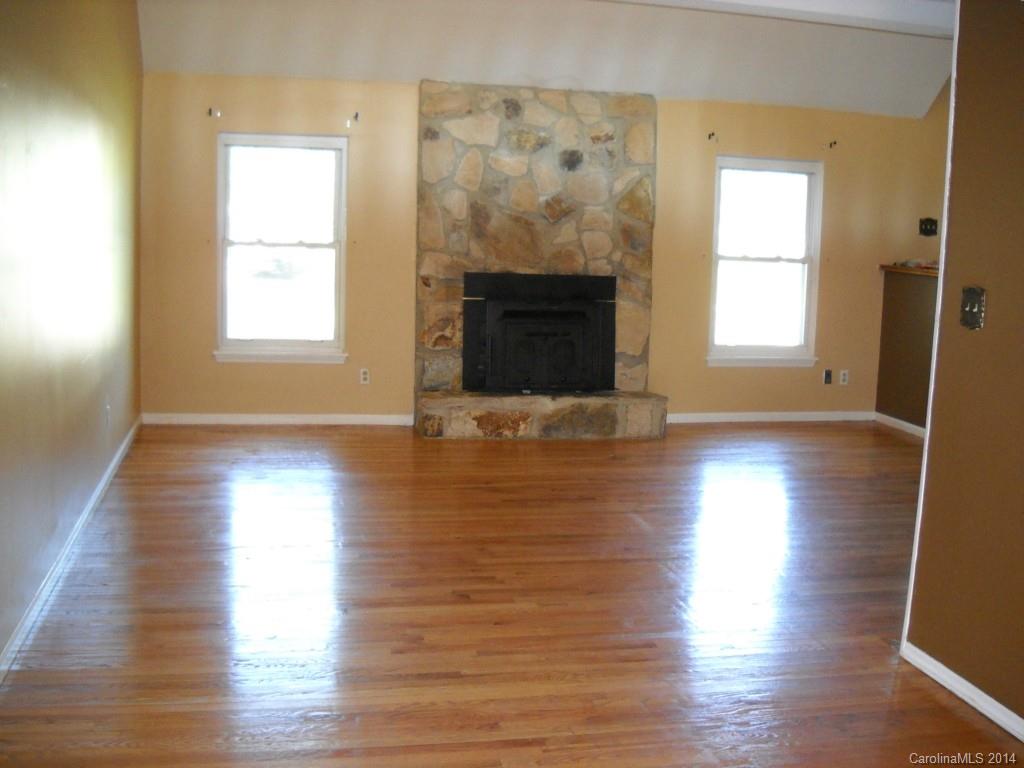 11405 Park Road Charlotte, NC 28226 - Photo 2 of 19 a view of an empty room with wooden floor and a window