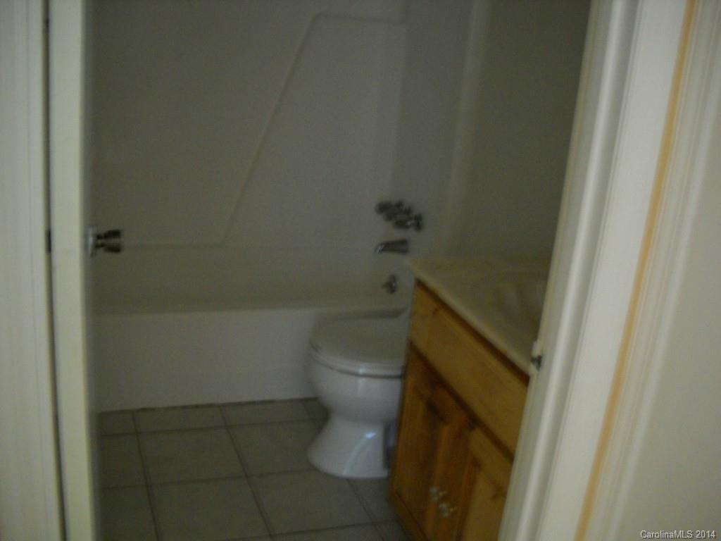 11405 Park Road Charlotte, NC 28226 - Photo 18 of 19 a white toilet sitting next to a shower