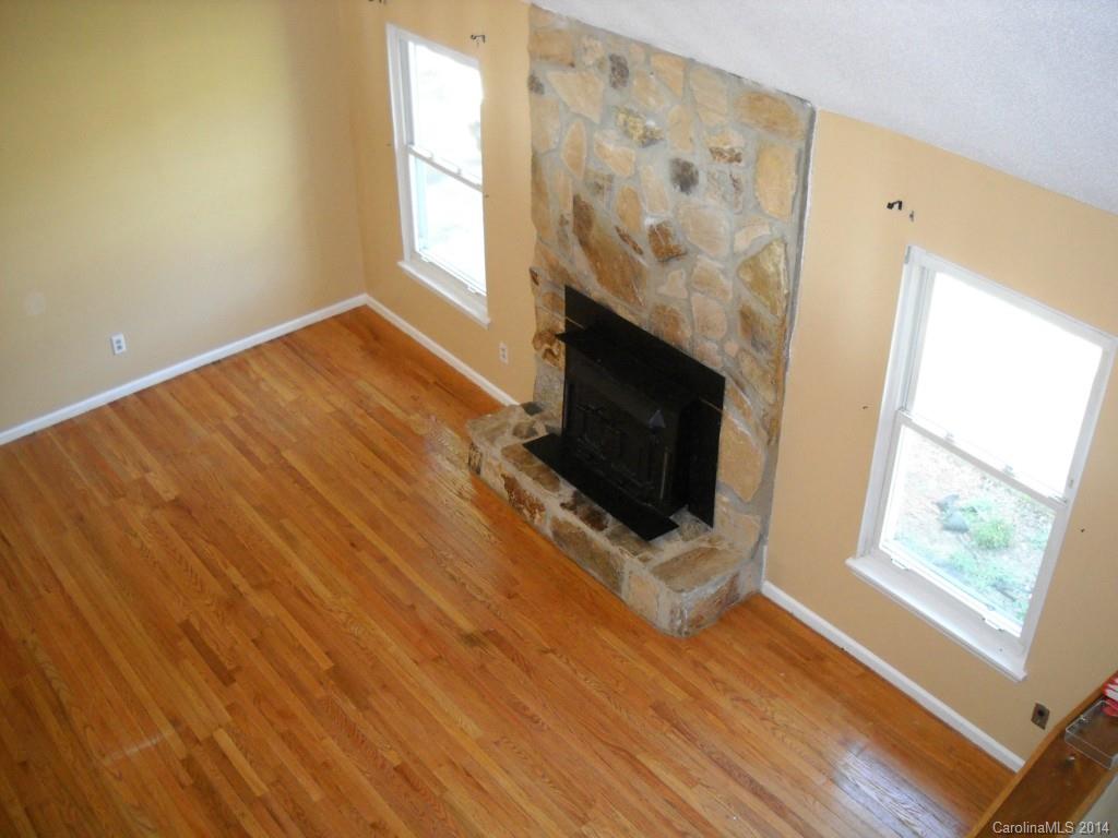 11405 Park Road Charlotte, NC 28226 - Photo 4 of 19 a living room with a fireplace and a flat screen tv