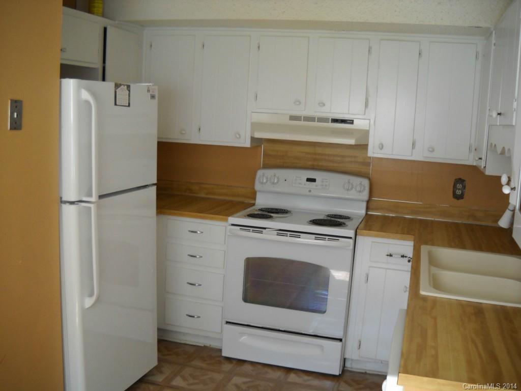 11405 Park Road Charlotte, NC 28226 - Photo 8 of 19 a kitchen with a refrigerator sink stove and cabinets