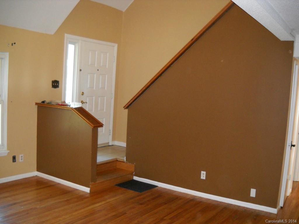 11405 Park Road Charlotte, NC 28226 - Photo 10 of 19 an empty room with wooden floor and windows