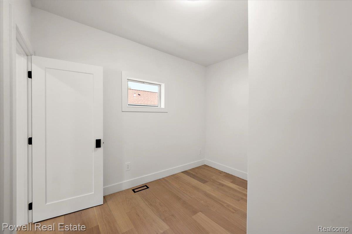 6837 Hatchery Road Waterford, MI 48327 - Photo 24 of 56 Unfurnished room with baseboards and light wood-type flooring