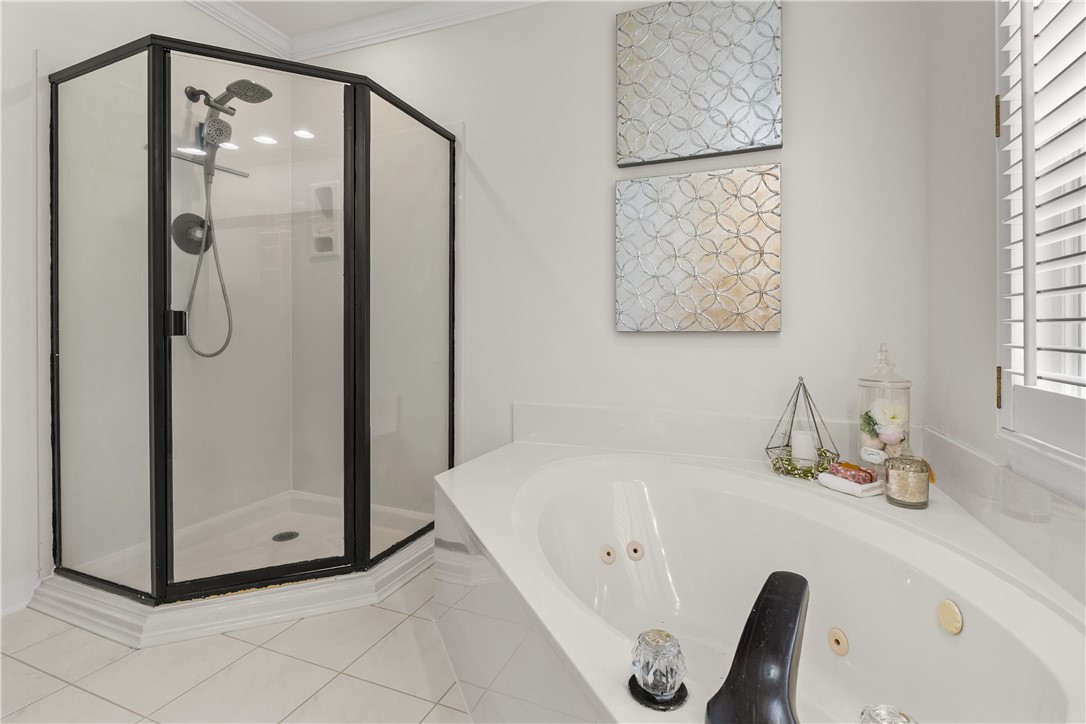 312 English Oak Road Simpsonville, SC 29681 - Photo 23 of 48 This bathroom features a clean design with a shower and a built-in tub.