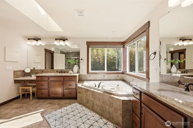 a large white kitchen with a large window and sink