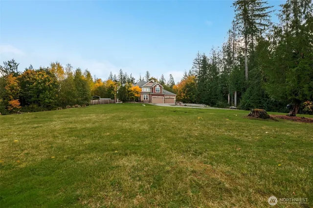 a view of a field with trees in the background