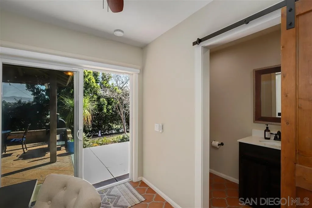1285 Palomino Road Fallbrook, CA 92028 - Photo 20 of 25 a view of a hallway and a livingroom with furniture