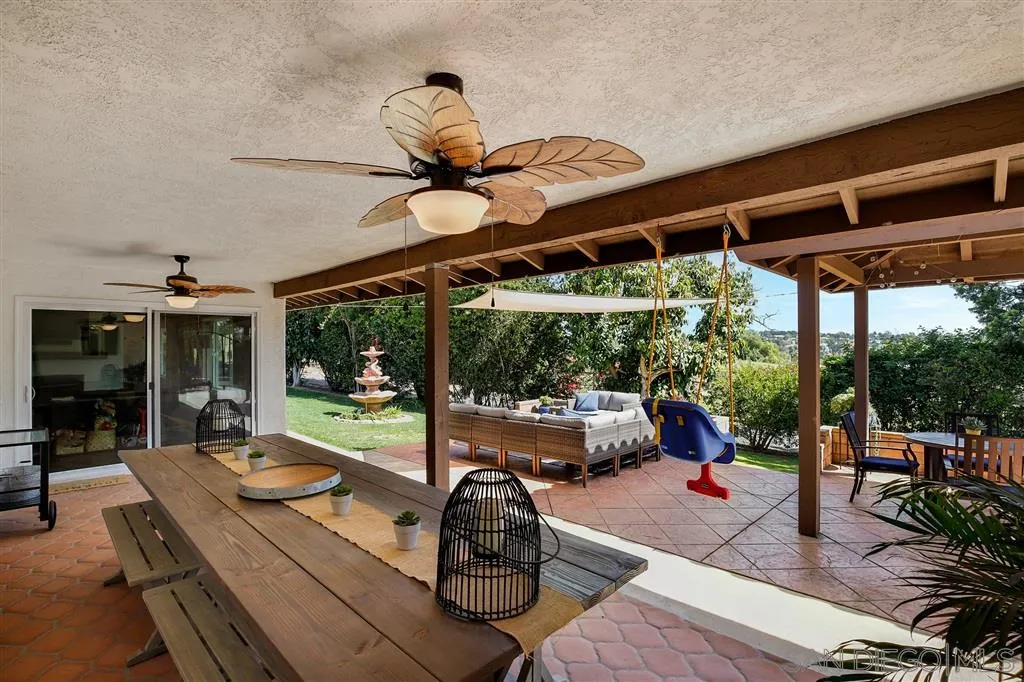 1285 Palomino Road Fallbrook, CA 92028 - Photo 21 of 25 a view of a patio with a table chairs and a backyard