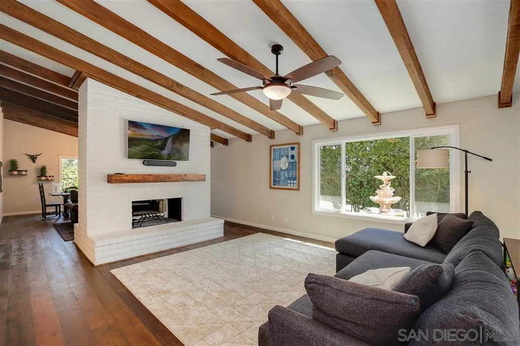 1285 Palomino Road Fallbrook, CA 92028 - Photo 8 of 25 a living room with furniture a flat screen tv and a fireplace