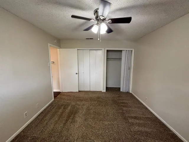 a view of a livingroom with a ceiling fan and a chandelier fan