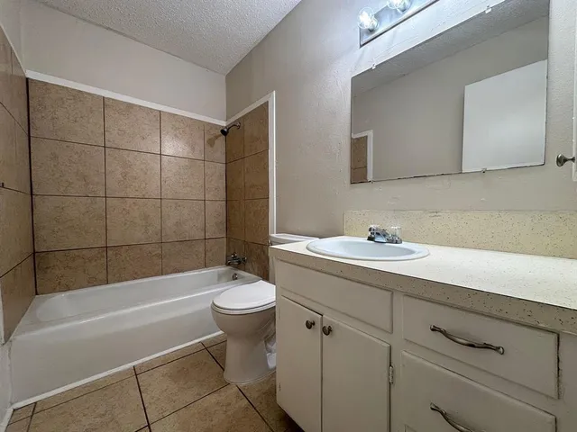 a bathroom with a sink mirror toilet and bathtub
