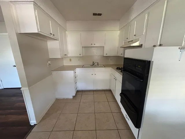 a kitchen with a sink and a refrigerator