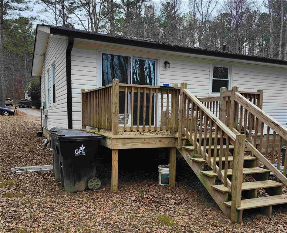 62 McClure Road Temple, GA 30179 - Photo 12 of 12 a view of a house with wooden deck and furniture