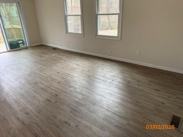 62 McClure Road Temple, GA 30179 - Photo 5 of 12 an empty room with wooden floor and windows