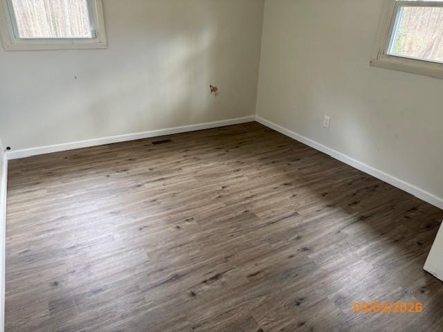 62 McClure Road Temple, GA 30179 - Photo 8 of 12 an empty room with wooden floor and windows