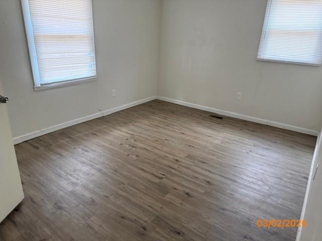 62 McClure Road Temple, GA 30179 - Photo 9 of 12 an empty room with wooden floor and windows