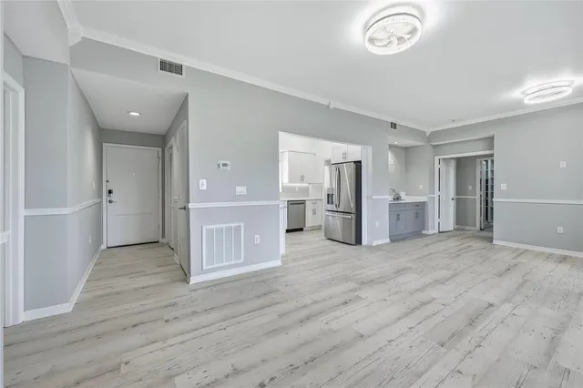a view of a kitchen with a refrigerator and a sink