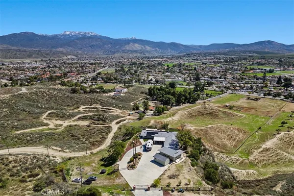 an aerial view of residential house and sandy dunes