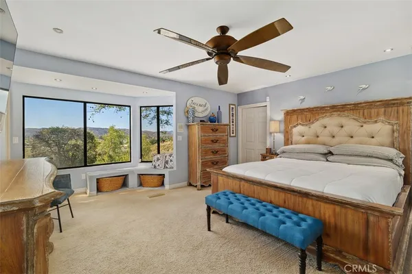 a bedroom with a bed and flat screen tv