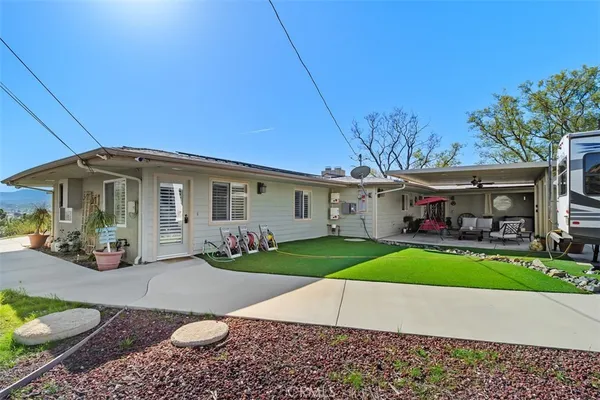 a front view of house with yard and outdoor seating