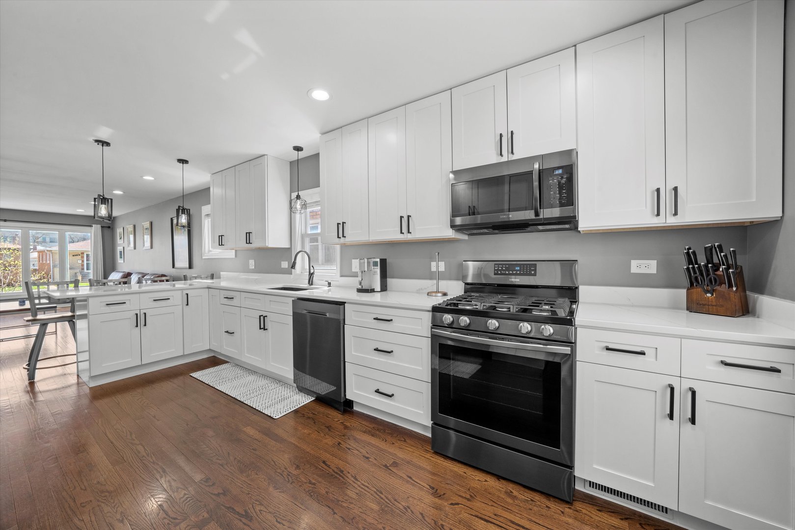 7114 West 64th Street Chicago, IL 60638 - Photo 11 of 43 a kitchen with stainless steel appliances granite countertop a stove a sink and a microwave