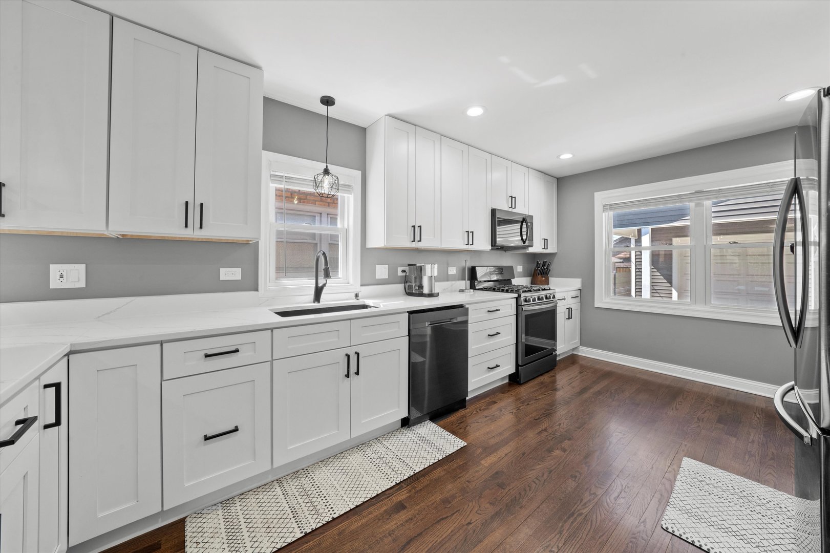 7114 West 64th Street Chicago, IL 60638 - Photo 13 of 43 a kitchen with granite countertop white cabinets and white appliances