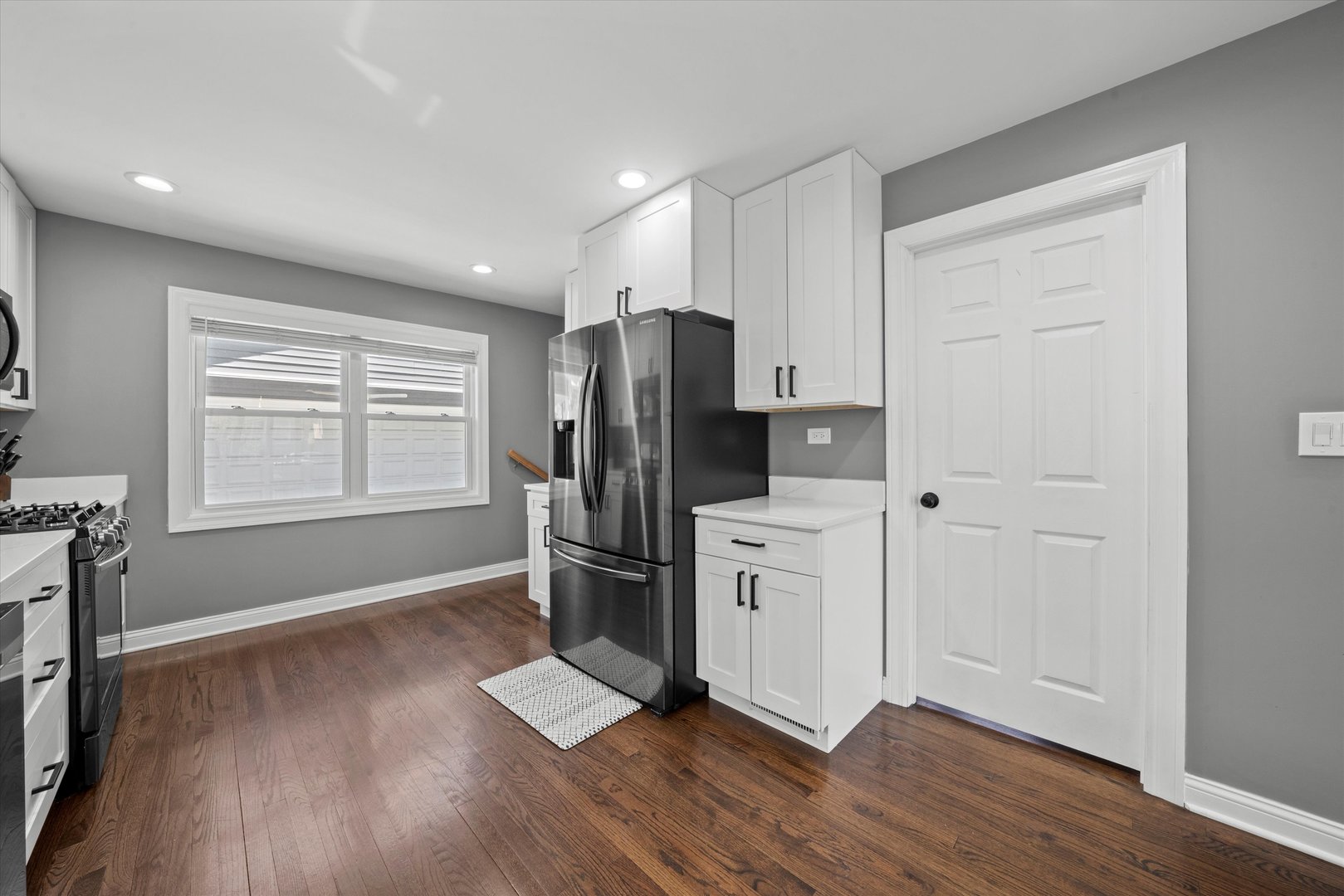 7114 West 64th Street Chicago, IL 60638 - Photo 14 of 43 a kitchen with stainless steel appliances a refrigerator and wooden floor