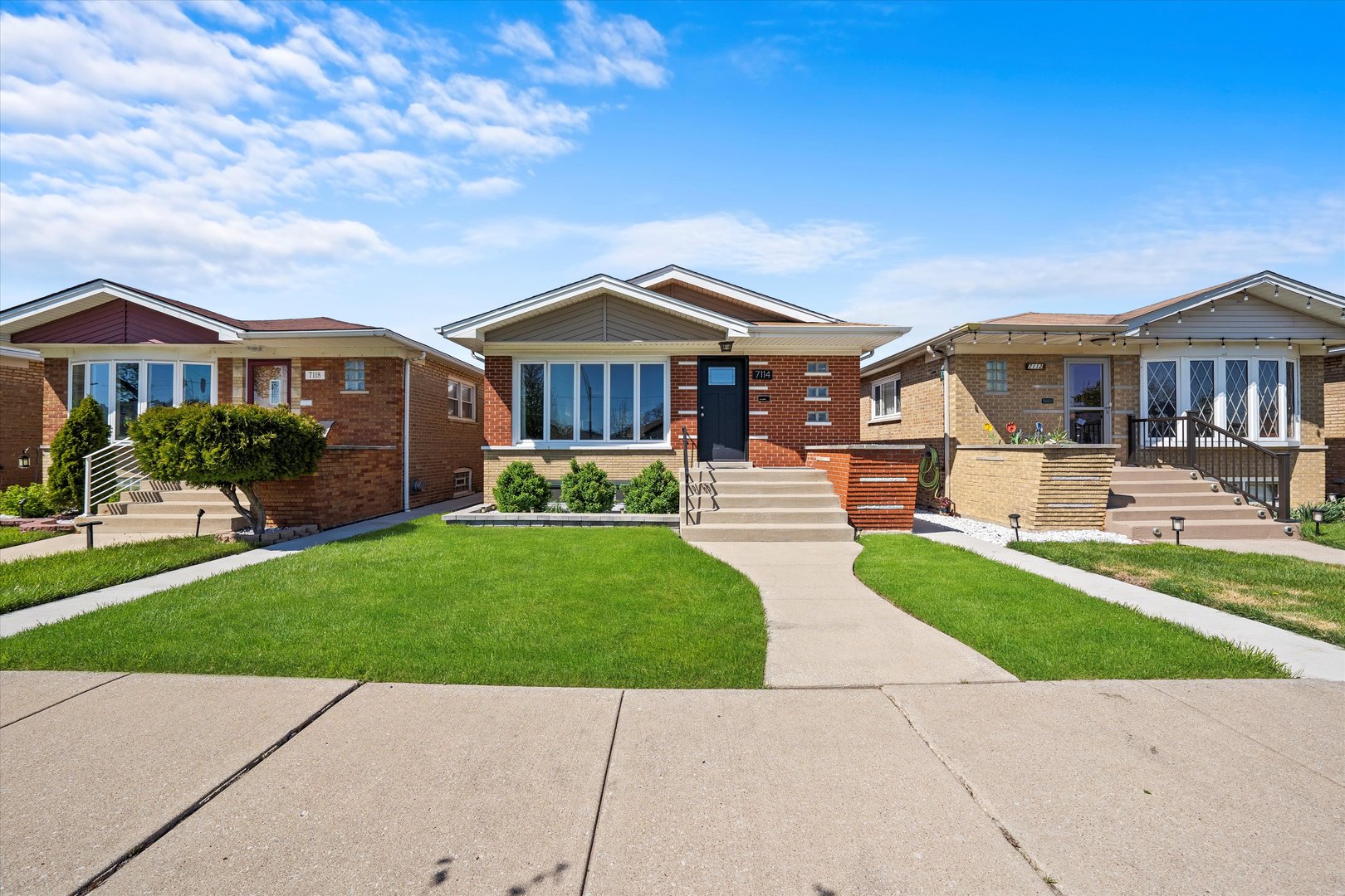 7114 West 64th Street Chicago, IL 60638 - Photo 2 of 43 a front view of a house with a yard