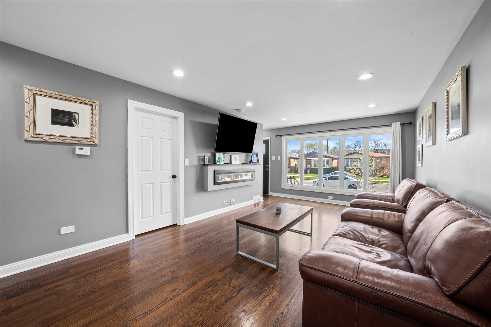 7114 West 64th Street Chicago, IL 60638 - Photo 8 of 43 a living room with furniture and a flat screen tv with wooden floor