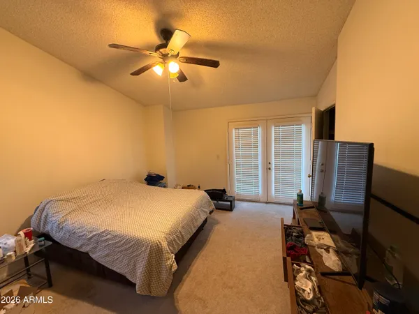 a bedroom with a bed and dresser with mirror