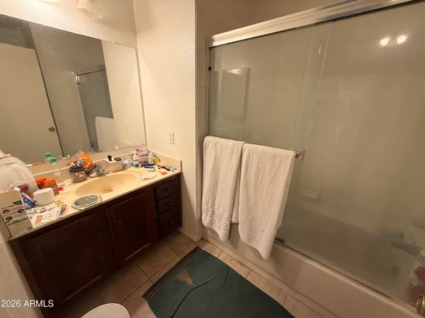 a bathroom with a sink a mirror and a shower