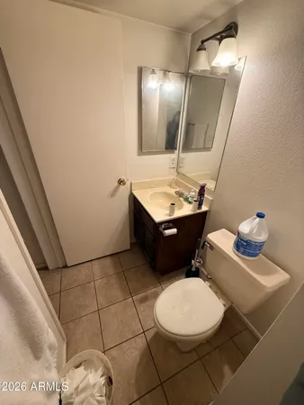 a bathroom with a sink toilet and mirror