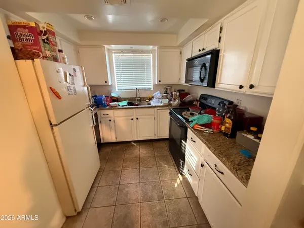 a kitchen with stainless steel appliances granite countertop a refrigerator and a stove
